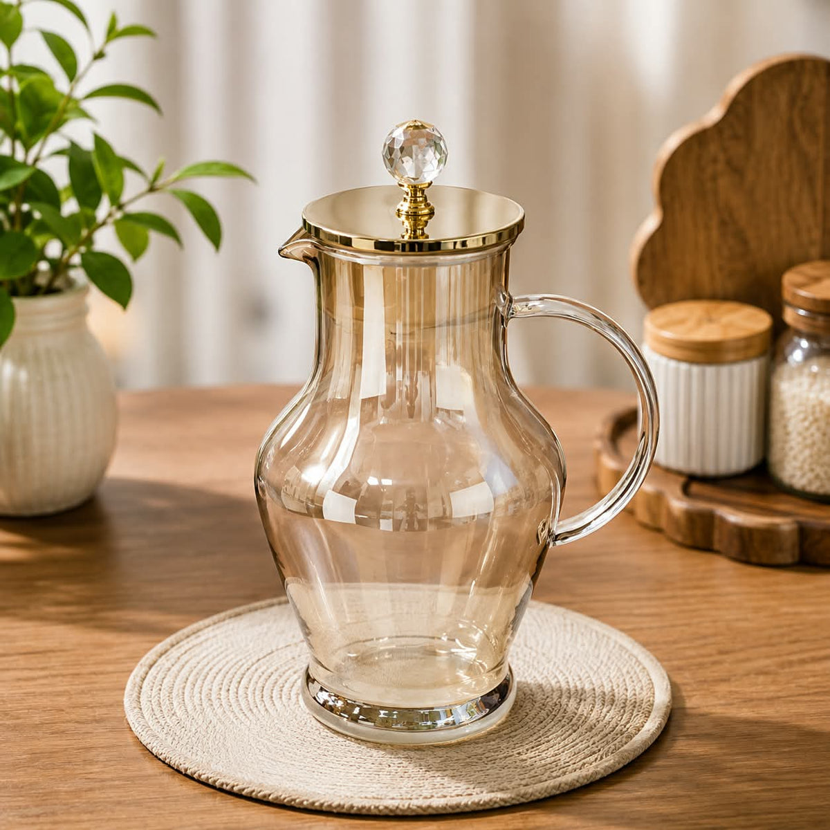 1700ml premium borosilicate glass jug with elegant gold finish for serving water, juice, lemonade, iced tea, and other beverages.