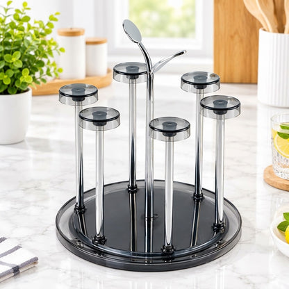 A 5-piece glass wine glass holder set with a round black base, five clear glass stems, and a central metal wine server, displayed on a white marble kitchen countertop.