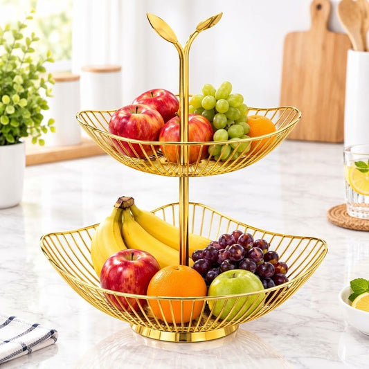 A two-tier gold wire fruit stand filled with fresh fruits like apples, bananas, grapes, and oranges, set on a marble kitchen countertop.