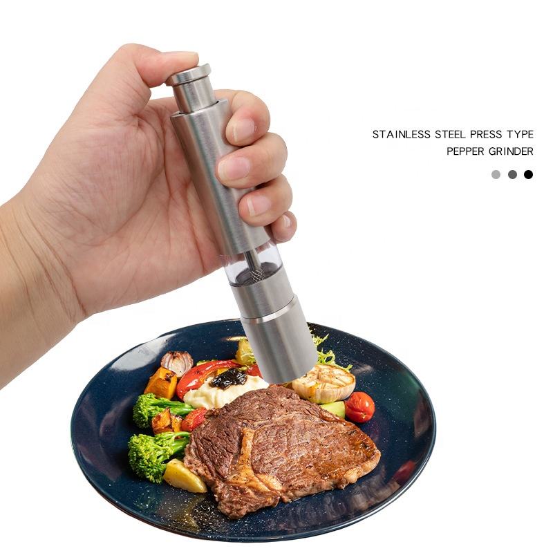 
Portable thumb press spice grinder for pepper and sea salt