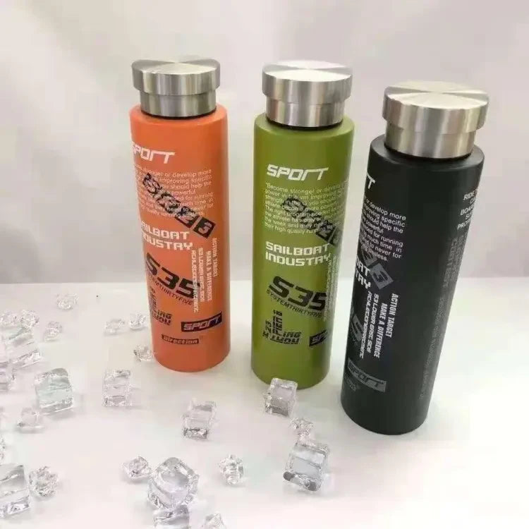 Three water bottles with 'S35' branding on a white surface with ice cubes.