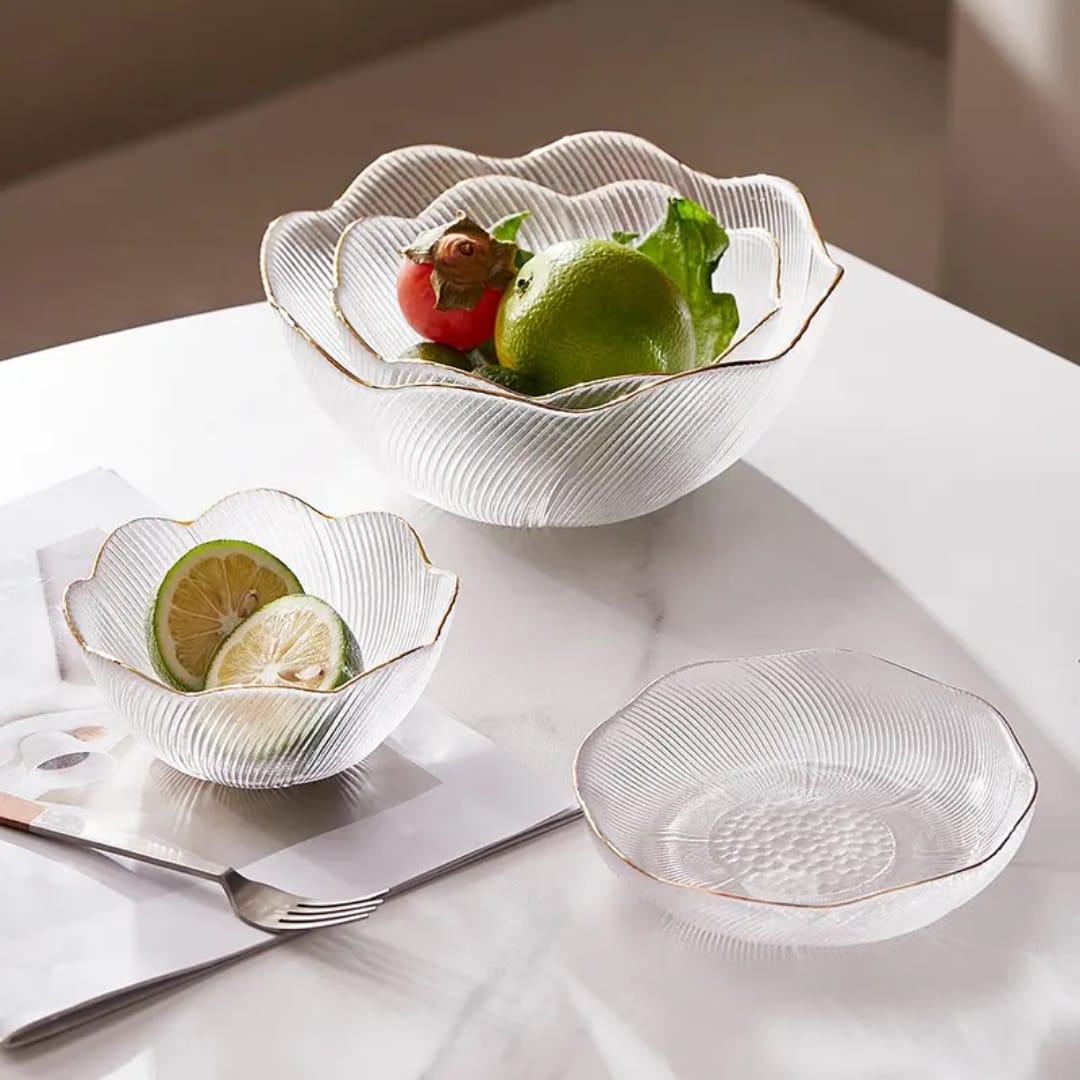 Decorative glass bowls with fruit on a marble surface