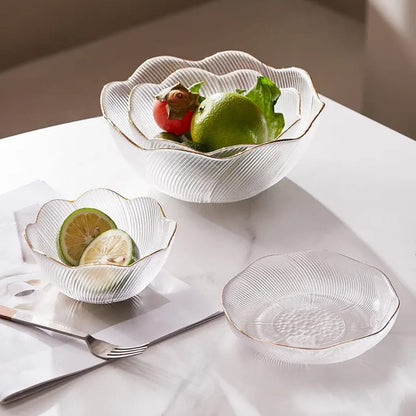 Decorative glass bowls with fruit on a marble surface