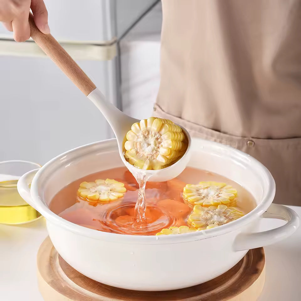 Person ladling soup with corn into a bowl